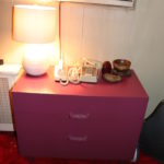 Pink Dresser With Assorted Items