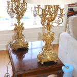 two gold candle light lamps