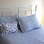 Full Bed With White Metal Headboard