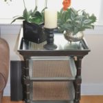 Thomasville Black Wood And Cane Side Table With Faux Plants And Candlesticks