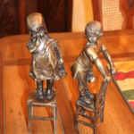 Pair Of 12T Bronze Children Perched On Stools