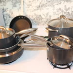 Analon Titanium Cookware Includes Assorted Pots, Pans, And Lids