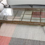 Metal And Glass Coffee Table With Beveled Glass And Detailed Apron