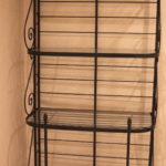 Metal And Glass Bakers Rack Shelf With Ornate Side Rails And Decorative Finial Tops