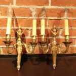 Pair Of Ornate Dual Arm Candlestick Style Wall Sconces With Brass Tone Finish