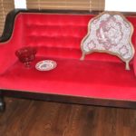Deep Red Sophisticated Tufted Settee With Studding Along Edges Includes Decorative Items