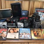 Mixed Lot Of Assorted Cameras, Handheld Devices, And DVDs,