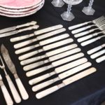 Assorted Lot Includes Mother Of Pearl And Sterling Handle Flatware With Waterford Champagne Flutes