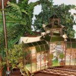 Handmade Glass House With Miniature Furniture Pieces And Decorative Plants