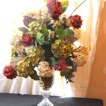 Large Crystal Footed Vase With Faux Hydrangea Floral Arrangement