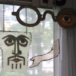 Hanging Wall Art Includes Large Glasses, Face, And Arm